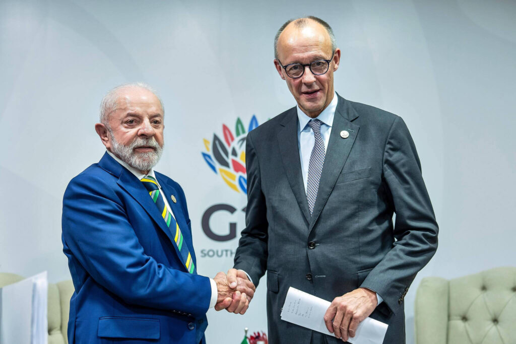 A picture of Lula da Silva (left) shaking hands with Merz.